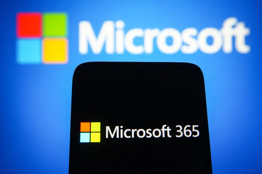 Microsoft 365 displayed on a phone in front of a Microsoft background